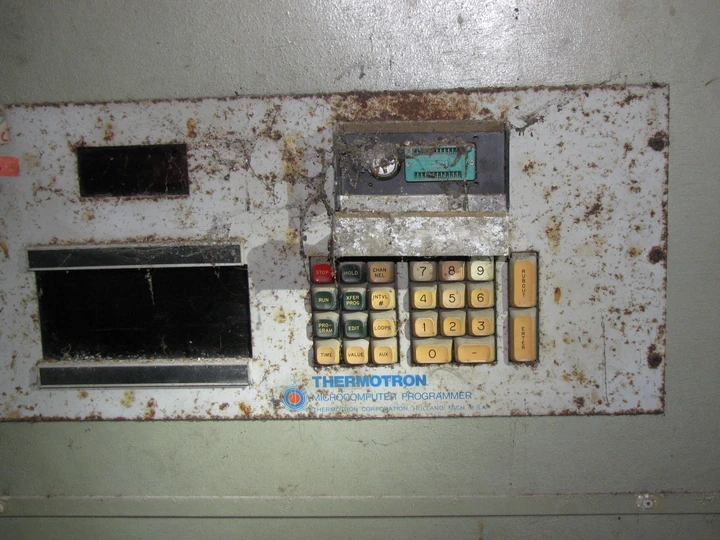 A dusty and rusted Thermotron microcomputer programmer control panel